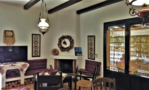 a dining room with a table and a fireplace at Gianni's village home in Aegina Town