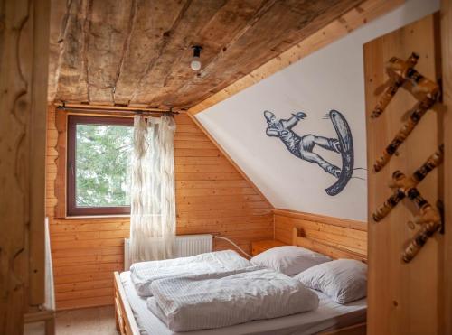 a bedroom with a bed in a wooden house at Готель Згарда in Dragobrat