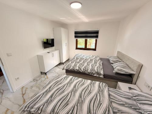 ein Schlafzimmer mit zwei Betten und einem großen Teppich in der Unterkunft Una Dreams in Bare