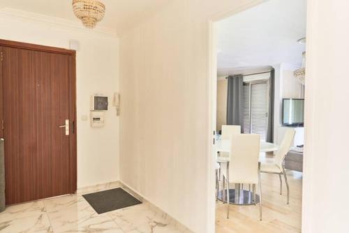 a living room with a table and a dining room at Appartement 3 pièces Nice-Ouest in Nice