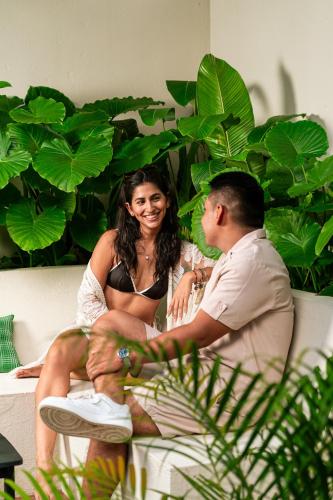 a man and a woman sitting on a couch at Private Pool Oasis in a Tropical Boutique Villa in San Carlos