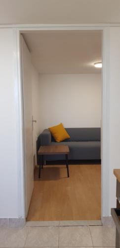 a couch with a yellow pillow in a room at Zusy in Orebić