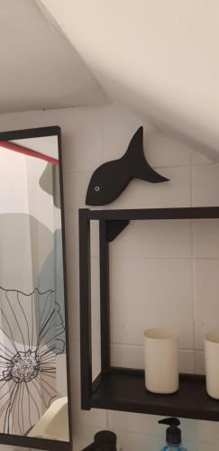 a shelf with a whale hat and a mirror at Zusy in Orebić