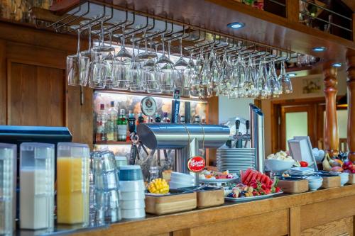 a bar with glasses hanging above a counter at Haus Windhook in Dierhagen