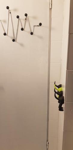 a bathroom with a shower with a black and yellow towel at Zusy in Orebić