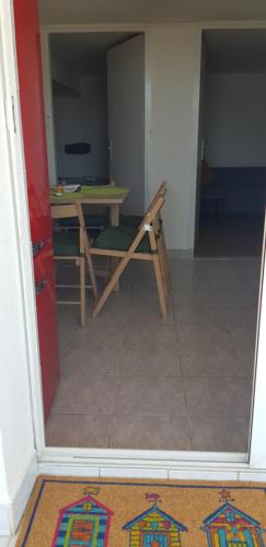 a room with a wooden table and a table and a table at Zusy in Orebić