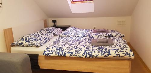 a bed with blue and white sheets and pillows at Zusy in Orebić