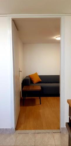 a black couch with a orange pillow in a room at Zusy in Orebić