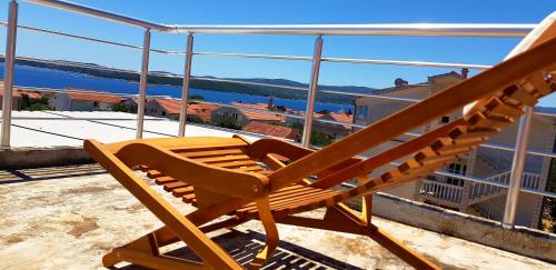 a wooden bench sitting on top of a balcony at Zusy in Orebić
