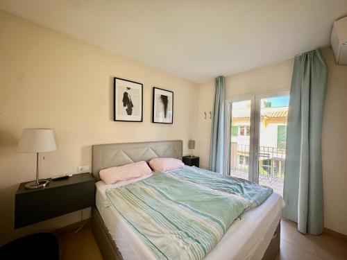 a bedroom with a bed and a window at Villa El Paraiso - Near Es Trenc in Campos