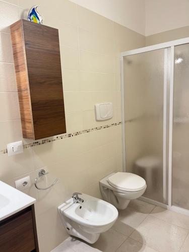 a bathroom with a toilet and a sink and a shower at Villa Costa del Sole - Capitolo in Monopoli