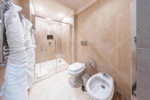 a bathroom with a toilet and a shower and a sink at Martius Private Suites Hotel in Rome