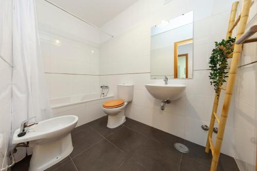 a white bathroom with a sink and a toilet at Sea waves - Olhão in Olhão