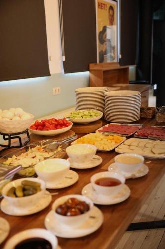 a table topped with plates and bowls of food at Intourist Kazbegi in Stepantsminda