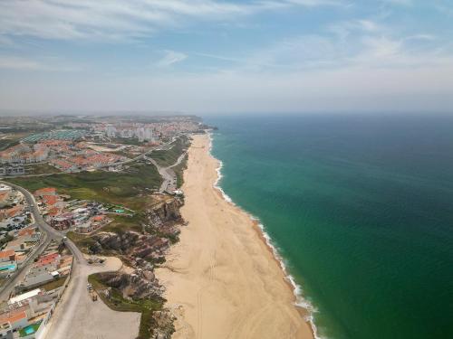 an aerial view of a beach and the ocean at Casa De Sousa-Refúgio de Surf entre Peniche e Ericeira in A dos Cunhados