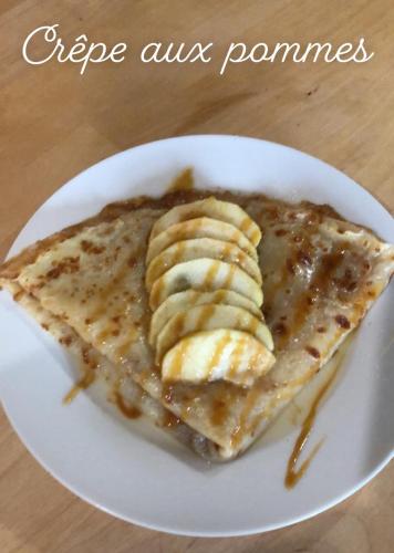 a plate of pancakes with sliced bananas on it at Le CLOS D'ETRETAT in Les Loges
