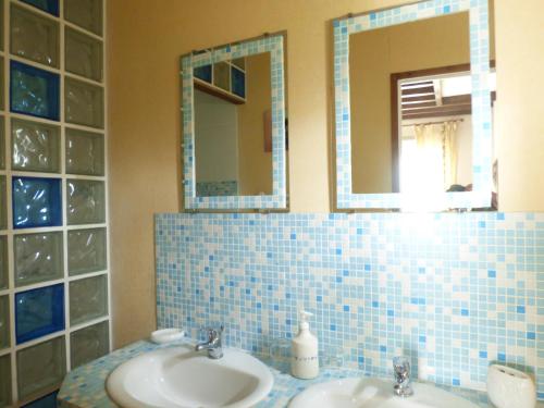 a bathroom with two sinks and two mirrors at Le CLOS D'ETRETAT in Les Loges