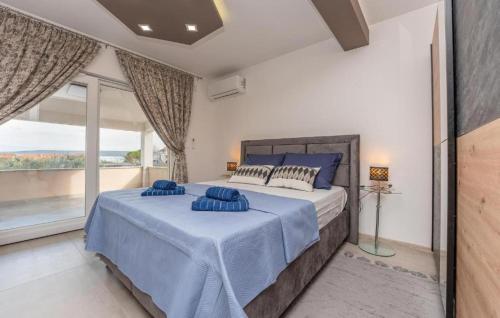 a bedroom with a large bed and a large window at Villa Emine in Banj