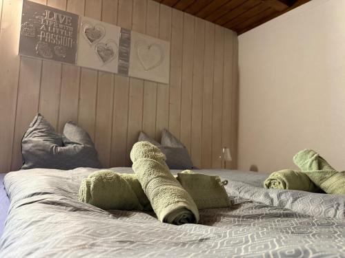 a bed with towels on top of it at Appartment Happy Life - Wimmis - near Spiez-Thun- Interlaken in Arni Alp