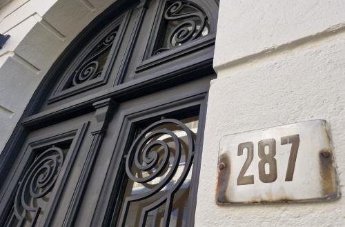 a door with a sign on the side of a building at FAUNA Montevideo in Montevideo