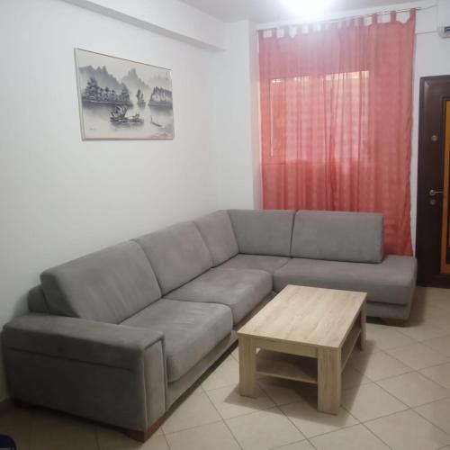 a living room with a couch and a coffee table at Saranda Kodra Underground Flat in Polisi i Vogël