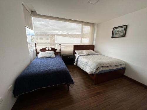 Postel nebo postele na pokoji v ubytování Instant Hotel - Departamentos de lujo en Ambato
