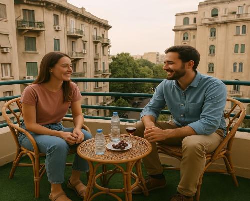a man and a woman sitting at a table on a balcony at Cairo Dream Boutique Hotel in Cairo