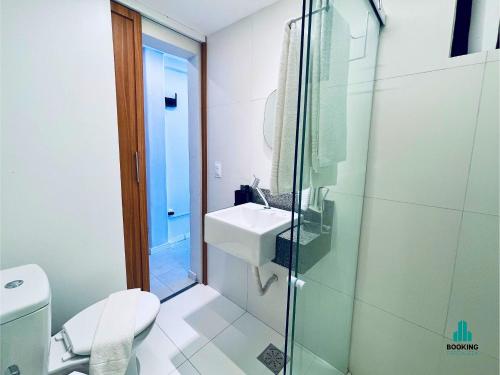 a bathroom with a toilet and a sink and a shower at Jacqueline Vista Mar by Holiday Stays in Fortaleza