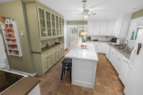a large kitchen with white cabinets and a counter at Graham Inn in New Glasgow