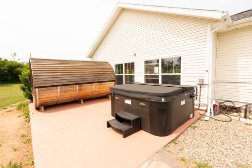 a barbecue grill on a patio next to a house at Graham Inn in New Glasgow