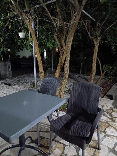 two chairs and a table and a table and chairs at Apartman Dali in Blagaj