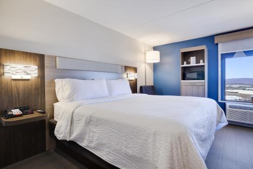 a hotel room with a large bed and a window at Holiday Inn Express Wilkes Barre East by IHG in Wilkes-Barre