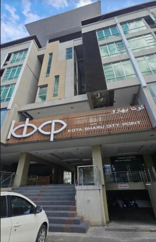 a white car parked in front of a building at MFM Studio Kbcp in Kota Bharu