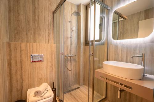 a bathroom with a shower and a sink and a toilet at DK Luxury Villas in Sivota