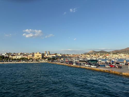 a view of a city with cars parked next to the water at Eleni Apartment in Perdhika