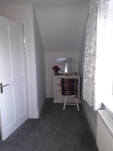 a small room with a table and a chair at mature 4 bedroom home with relaxing garden and wonderful views in Carlow