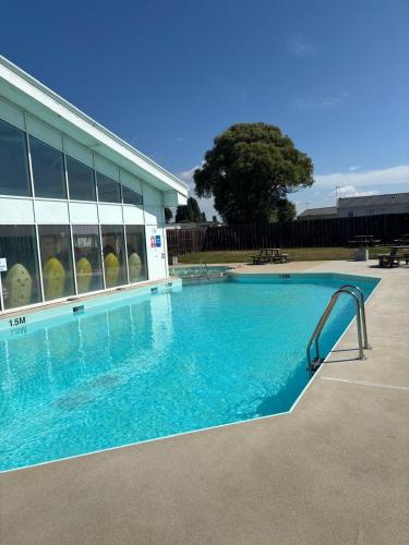 a swimming pool with a slide in front of a building at Ultimate serene getaway in East Mersea