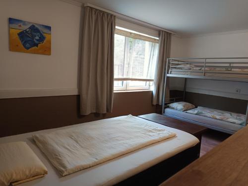 a bedroom with two bunk beds and a window at Tengelice-ház in Réde