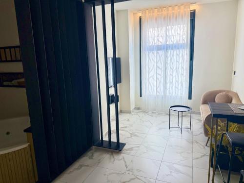 a living room with a large window and a table at Reina Victoria La Plaza in Alicante