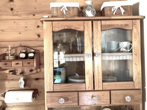 a wooden hutch with plates and dishes in it at Liptovská Drevenica in Liptovský Mikuláš