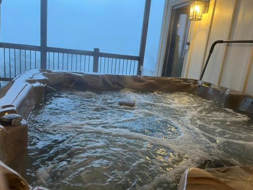 a hot tub in the middle of a room with water at Exclusive Lakefront Retreat on Douglas Lake in Dandridge