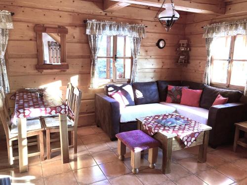 a living room with a couch and two tables at Liptovská Drevenica in Liptovský Mikuláš