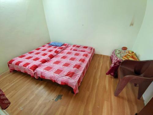 a bedroom with a bed and a chair in a room at HIMALAYAN Triund Trekking and Snowline Trekking, Waterfalls View Hostel in McLeod Ganj