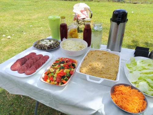 a table with different types of food on it at Dreamvilles Ecovillage Las Galeras in Las Galeras