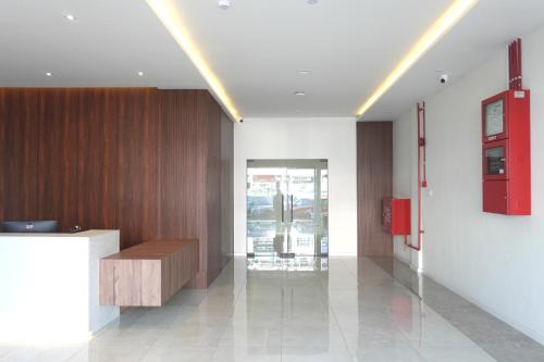 a lobby with a desk and a red box on the wall at sohho Hotel in Cukai