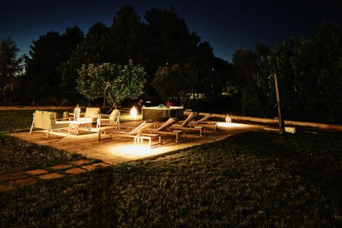 a group of chairs and a table with lights at Dimora Donna Rita - B&B in Lecce