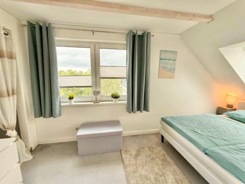 a bedroom with a bed and a window at Idyllisches Dorfhaus vor Usedom in Gützkow