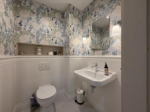 a bathroom with a toilet and a sink at Cosmo Apartments Baltic Sea in Gdańsk