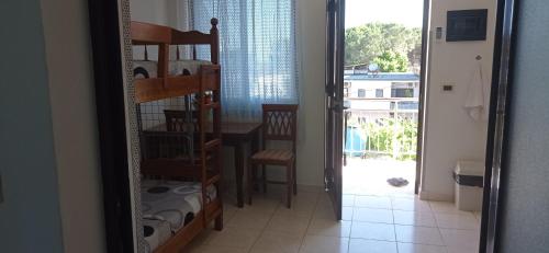 a mirror in a room with a table and a balcony at A & H Apartments Velipoje in Velipojë