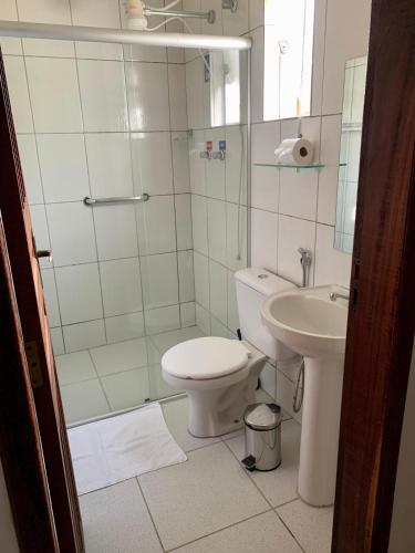 a bathroom with a toilet and a sink at Pousada do Guinda DIAMANTINA -MG in Diamantina